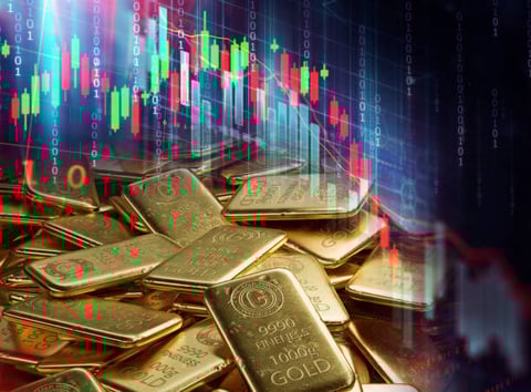 Gold bars with trading charts